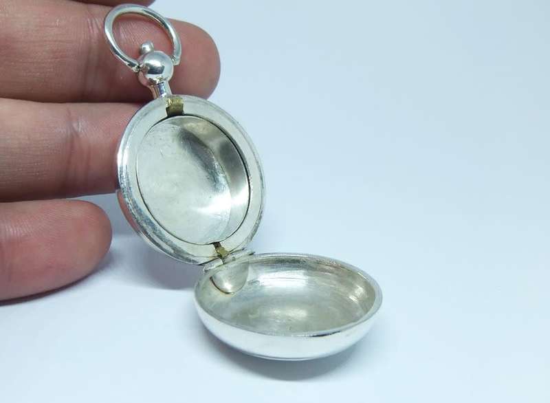 A vintage Birmingham hallmarked  sterling silver pill holder fob with spring action clip