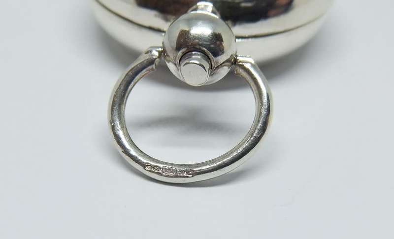 A vintage Birmingham hallmarked  sterling silver pill holder fob with spring action clip