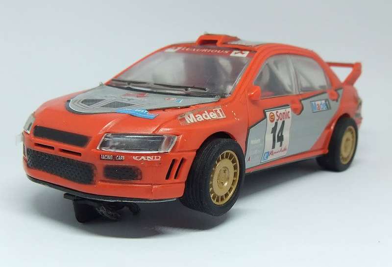 A vintage scalextric car with advertising , driver with co-driver aka navigator