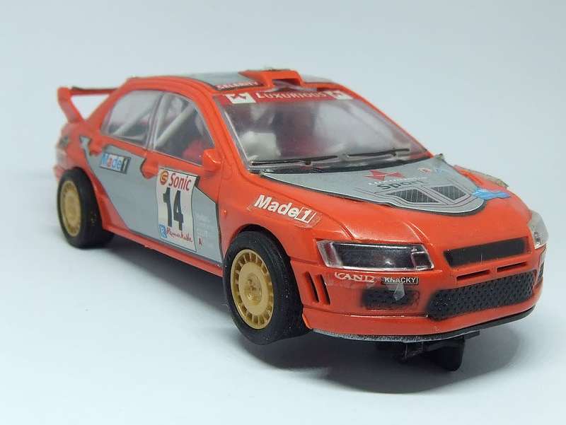 A vintage scalextric car with advertising , driver with co-driver aka navigator