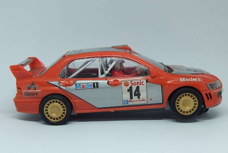 A vintage scalextric car with advertising , driver with co-driver aka navigator