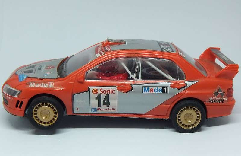 A vintage scalextric car with advertising , driver with co-driver aka navigator