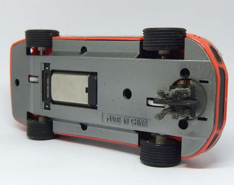A vintage scalextric car with advertising , driver with co-driver aka navigator
