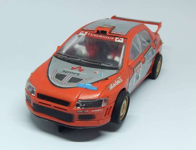 A vintage scalextric car with advertising , driver with co-driver aka navigator