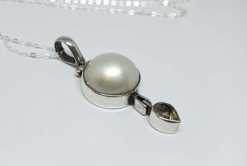 A sterling silver pendant with Mabe pearl and faceted inset plus brand new sterling silver necklace
