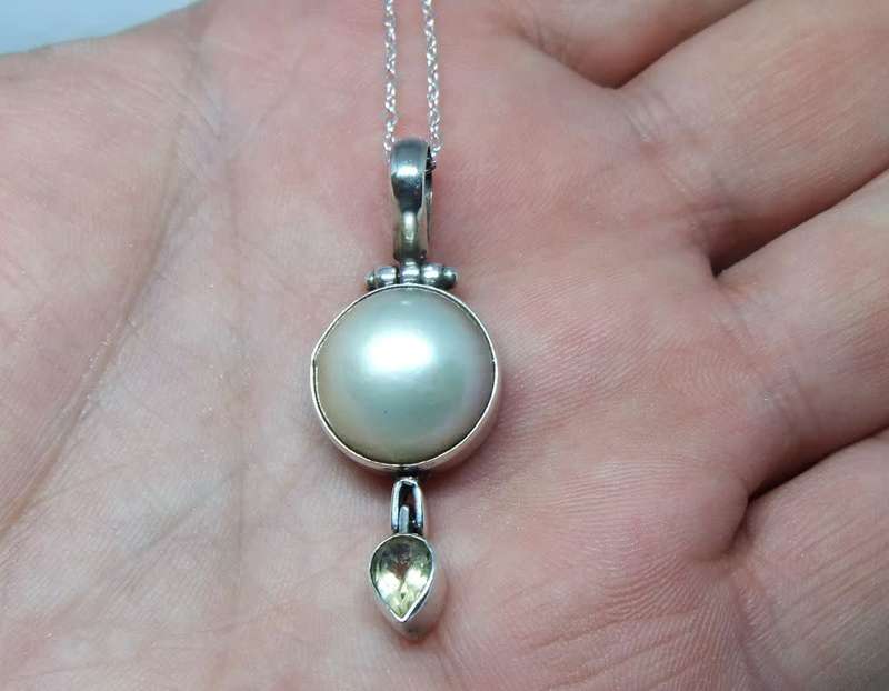 A sterling silver pendant with Mabe pearl and faceted inset plus brand new sterling silver necklace