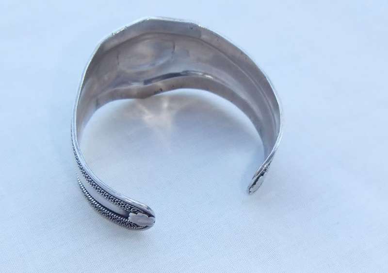 A solid sterling silver cuff bangle with a green cabochon inset - stamped & tested