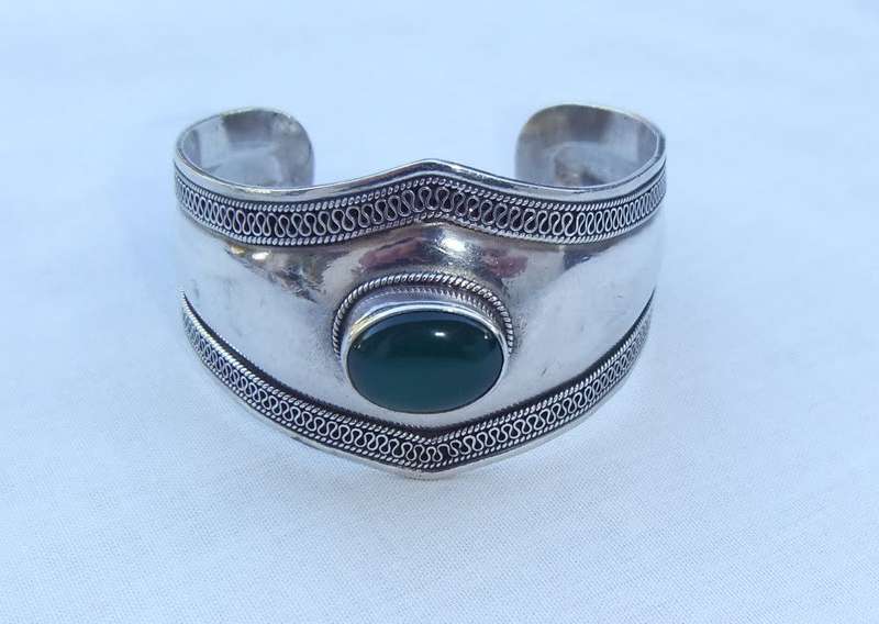 A solid sterling silver cuff bangle with a green cabochon inset - stamped & tested