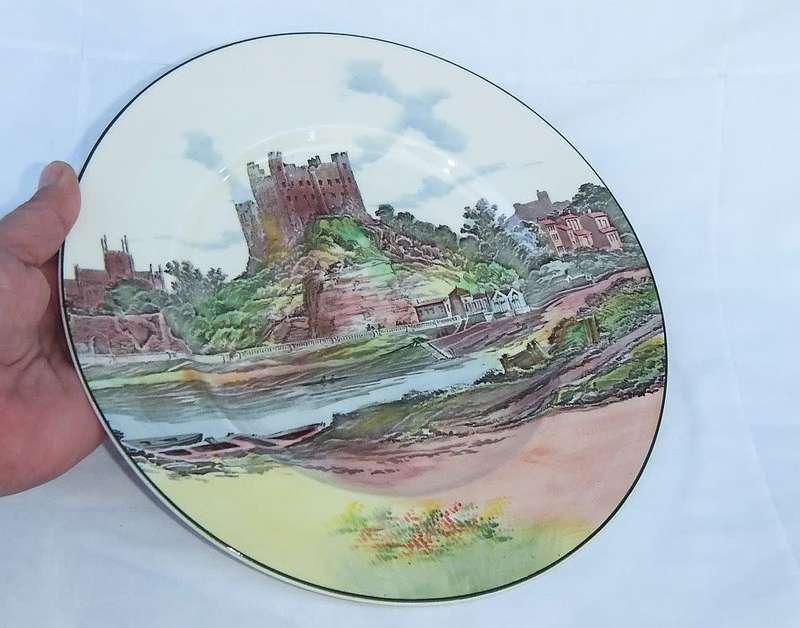 A stunning old cabinet or display plate depicting a castle scene made by Royal Doulton England