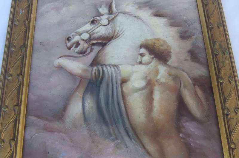 An eye catching framed oil painting depicting a man with a raging horse