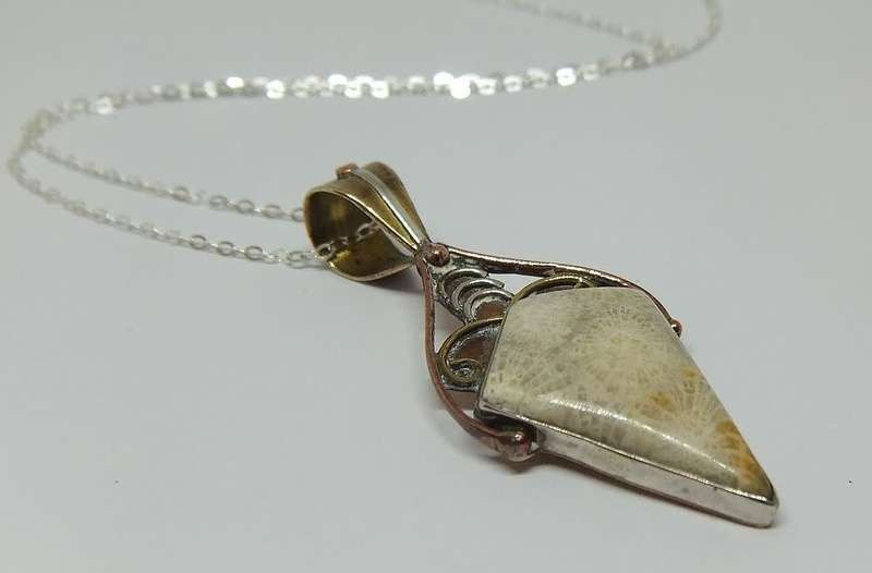 An unusually designed genuine sterling silver and other metal pendant & a sterling silver necklace