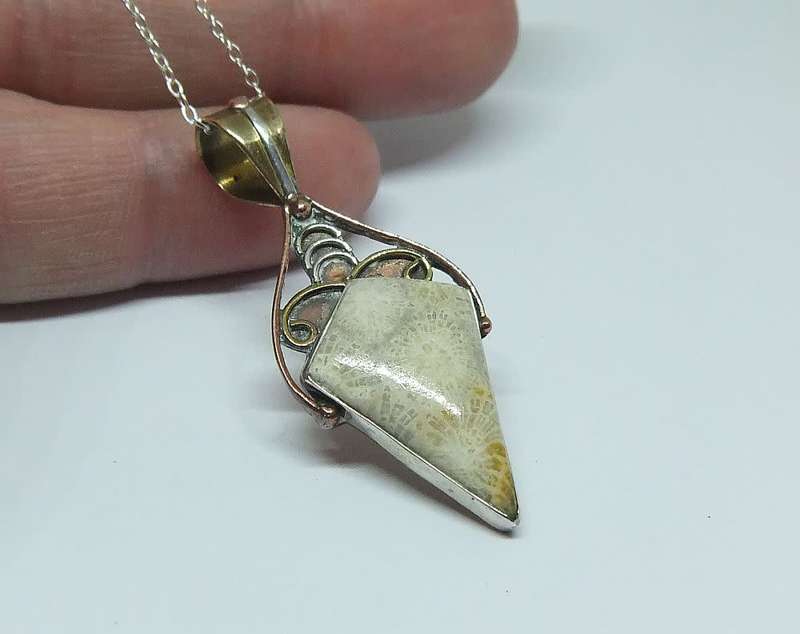 An unusually designed genuine sterling silver and other metal pendant & a sterling silver necklace