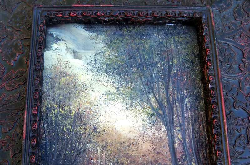 An original signed miniature oil painting depicting a cottage in the forrest with river passing