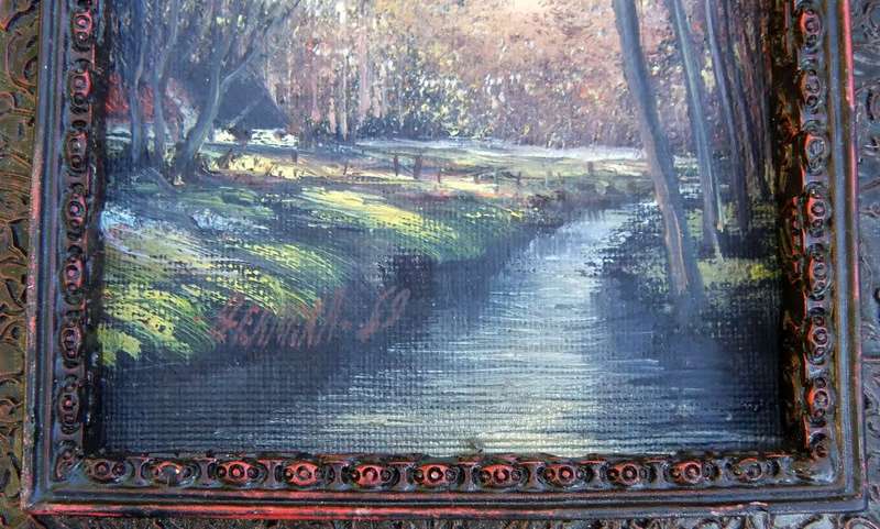 An original signed miniature oil painting depicting a cottage in the forrest with river passing