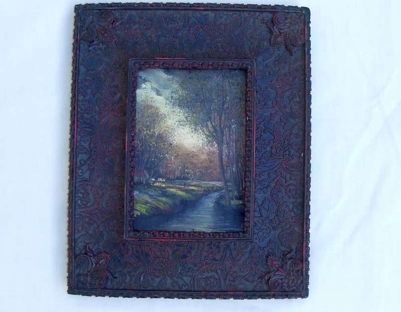 An original signed miniature oil painting depicting a cottage in the forrest with river passing