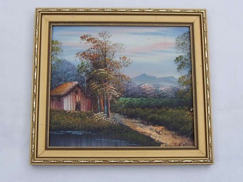 A CHARMING SIGNED OIL ON BOARD PAINTING DEPICTING A COTTAGE IN THE FORREST AT THE LAKE