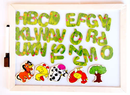 Wooden white board with magnetic alphabet letters