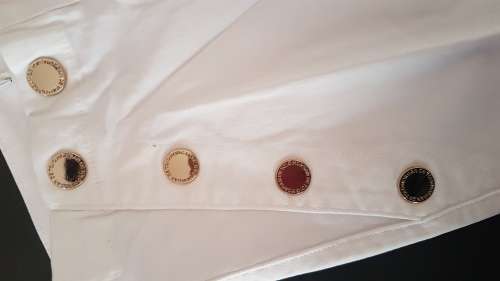 White jeans with gold buttons.  Size 26, 28, 30 and 34 available