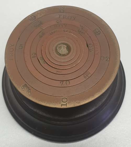 Antique 7 pce set of brass Troy ounce nesting cup weights.
