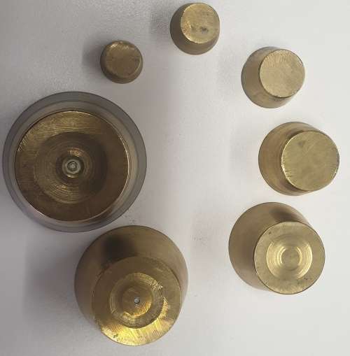 Antique 7 pce set of brass Troy ounce nesting cup weights.