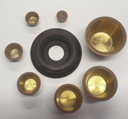 Antique 7 pce set of brass Troy ounce nesting cup weights.