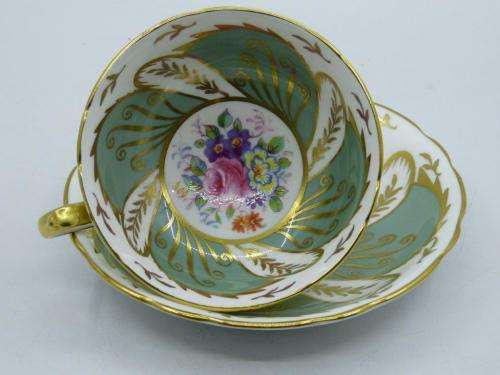 PARAGON VINTAGE GILDED AND SAGE-GREEN FOOTED TEA CUP AND SAUCER WITH CABBAGE ROSES.