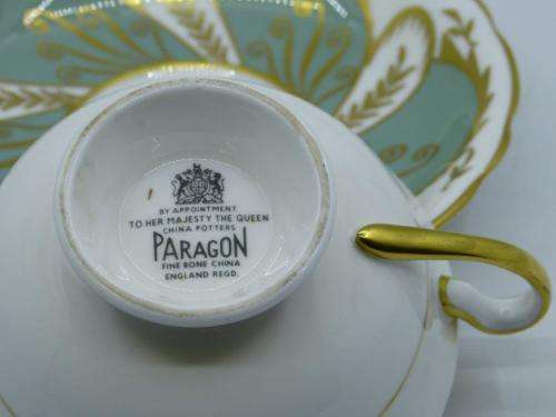 PARAGON VINTAGE GILDED AND SAGE-GREEN FOOTED TEA CUP AND SAUCER WITH CABBAGE ROSES.