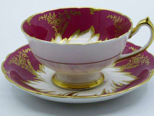 PARAGON GILDED AND CARDINAL RED VINTAGE TEA CUP DUO WITH CABBAGE ROSES .