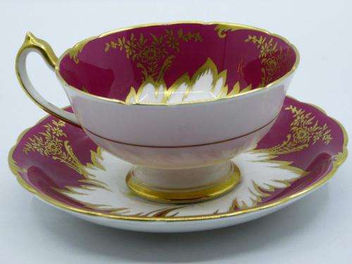 PARAGON GILDED AND CARDINAL RED VINTAGE TEA CUP DUO WITH CABBAGE ROSES .
