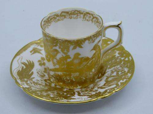 ROYAL CROWN DERBY DEMI TASSE AND SAUCER IN THE GOLD AVES  PATTERN.