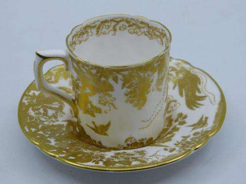 ROYAL CROWN DERBY DEMI TASSE AND SAUCER IN THE GOLD AVES  PATTERN.
