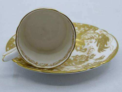 ROYAL CROWN DERBY DEMI TASSE AND SAUCER IN THE GOLD AVES  PATTERN.
