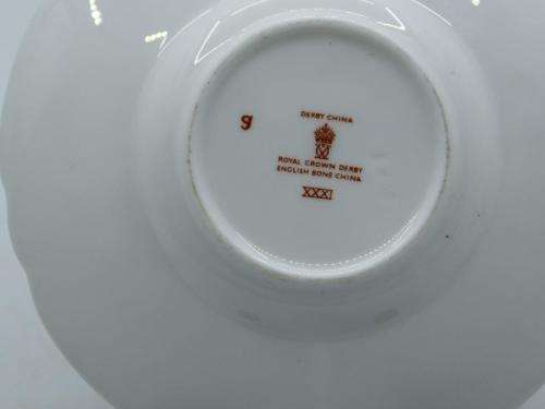 ROYAL CROWN DERBY DEMI TASSE AND SAUCER IN THE GOLD AVES  PATTERN.