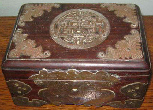 ANTIQUE CHINESE WOODEN TRINKET BOX WITH PLENTY OF BRASS DETAIL.