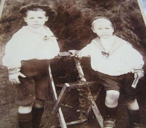 ANTIQUE PHOTO OF TWO SMALL BOYS DRESSED IN THEIR SAILOR SUITS.