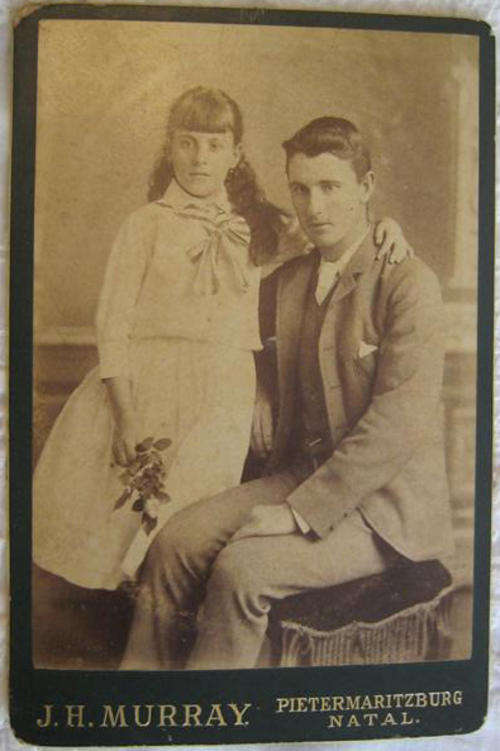 ANTIQUE STUDIO PHOTOGRAPH ON BOARD, OF A BROTHER AND SISTER.