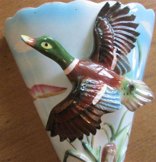 VINTAGE, HAND PAINTED CAPRI WALL POCKET FEATURING A FLYING DUCK IN RELIEF.