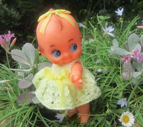 CUPIE RUBBER DOLL DRESSED IN HER PRETTY YELLOW DRESS AND PANTIES.