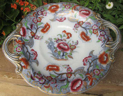 ANTIQUE, COMPLETELY HAND PAINTED AND  WITH GOLD HIGHLIGHTING TAZZA (CAKE STAND) WITH HANDLES