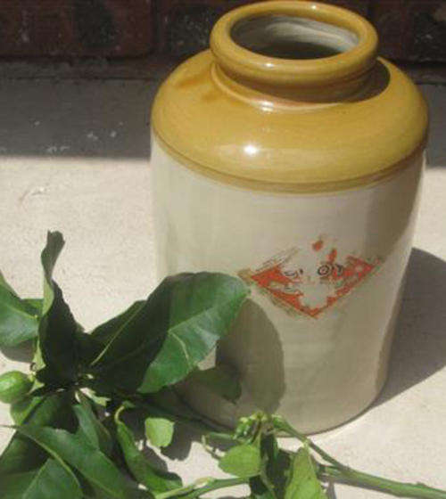 ANTIQUE STONEWARE STORAGE POT, REMAINS OF ORIGINAL LABEL.