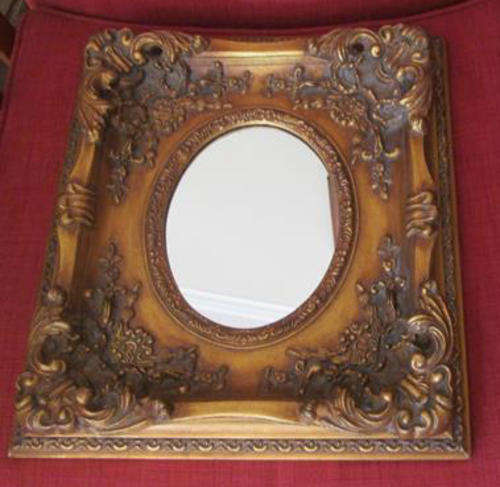 ANTIQUE LOOKING COPY, OF A LARGE ORNATE GILDED FRAME AND OVAL MIRROR