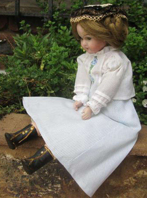 ANTIQUE GERMAN DOLL, WOOD FILLED BODY, BISQUE HEAD , COMPOSITION LEGS, ORIGINAL CLOTHES