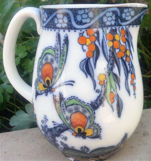 ANTIQUE, LOSOL WARE, KEELING & CO HAND PAINTED OVER TRANSFER JUG IN THE DESIGN PAPILLON
