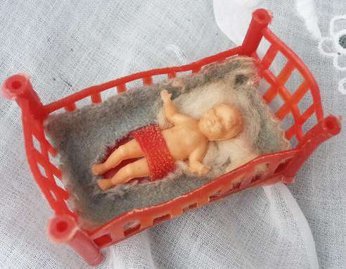 VINTAGE MINIATURE PLASTIC DOLL SLEEPING  IN HER COT