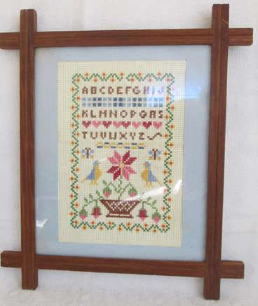 PRETTY VINTAGE CROSS STITCH  SAMPLER , FRAMED BEHIND GLASS.
