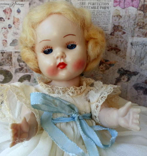 VINTAGE ROSEBUD BABY DOLL, BLONDE MOHAIR WIG, BLUE OPEN / SHUT EYES, ORIGINAL CLOTHING.