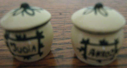 TWO STORAGE POTS, HEIGHT 1CM, CIR. 1 CM.