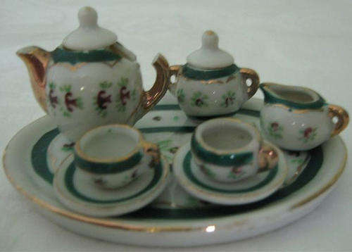 R1.00   MINIATURE TEA SET ON TRAY, DAMAGED TEA POT, MARKED FOREIGN.