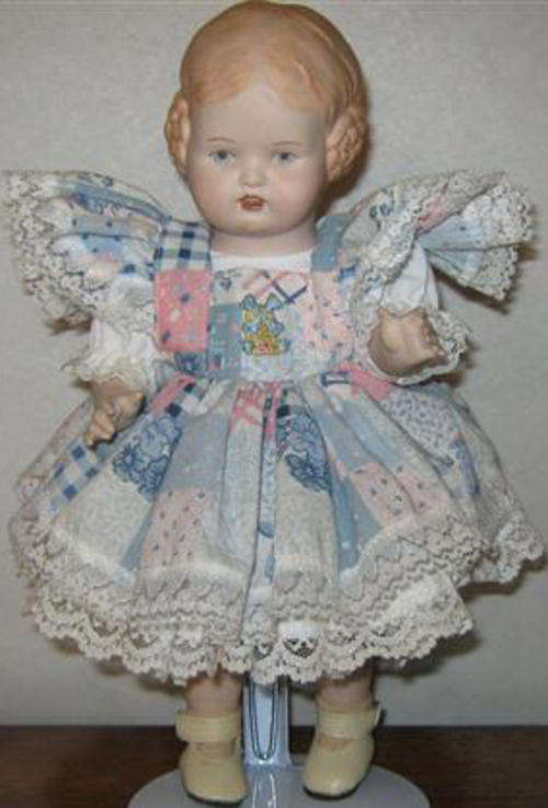 VINTAGE LOOKING, WELL DRESSED LITTLE GIRL WITH OLD FASHIONED HAIR STYLE.