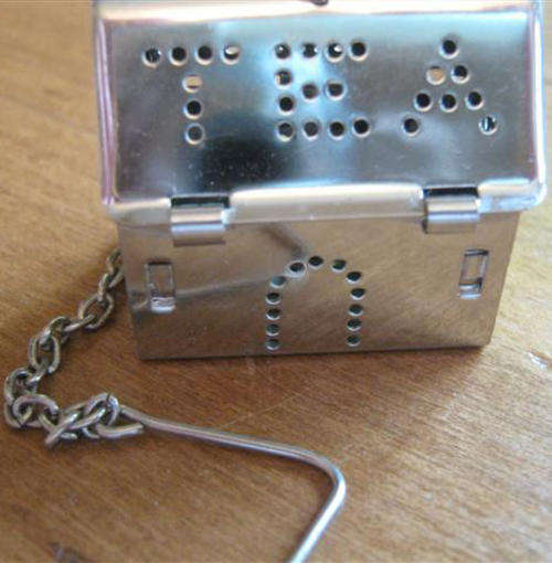 SILVER METAL, LOOSE TEA  LEAF CONTAINER, SHAPED AS A HOUSE WITH A CHAIN .